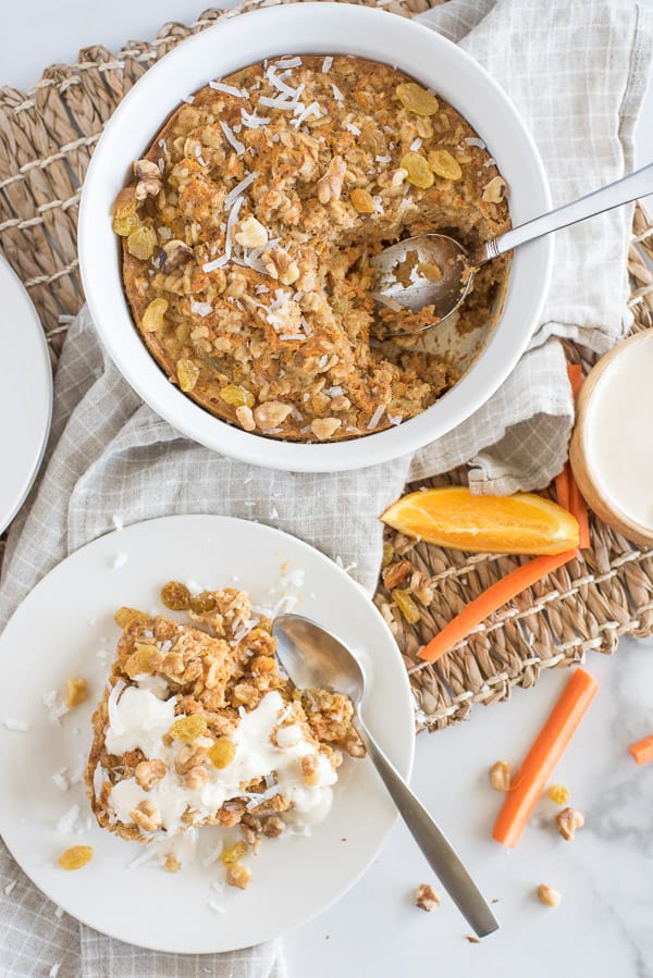Instant Pot Carrot Cake Oatmeal on a white plate with white yogurt sauce over top