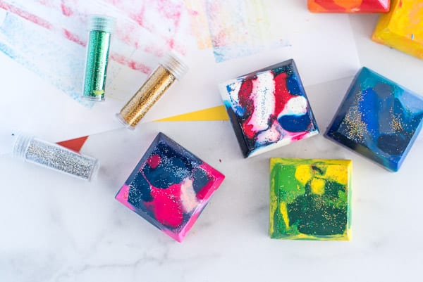 Square crayons of many different colors with glitter