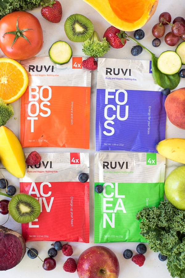 packets of freeze dried fruit surrounded by fruits and vegetables