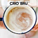crio bru in a white cup held in hands