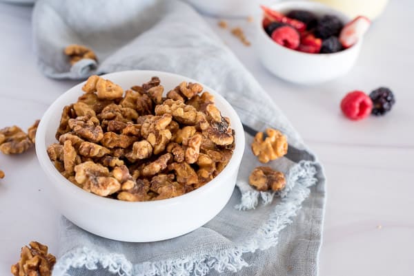 sweet and spicy roasted walnuts in a white bowl