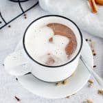 cup of hot chocolate Crio Bru on a white plate with a spoon