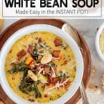 Tuscan White Bean Soup in a white bowl with a spoon