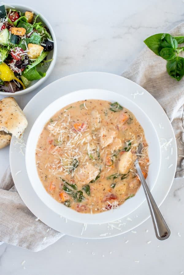Chicken and gnocchi soup in a white bowl