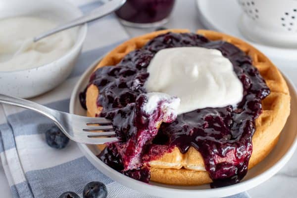 waffles with blueberry syrup and whipped cream