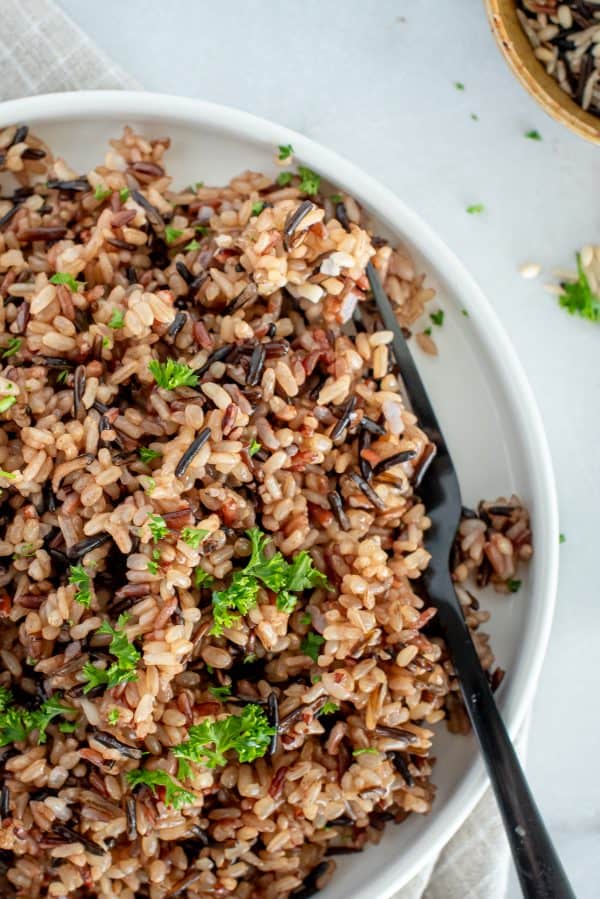 wild rice on a white plate with herbs
