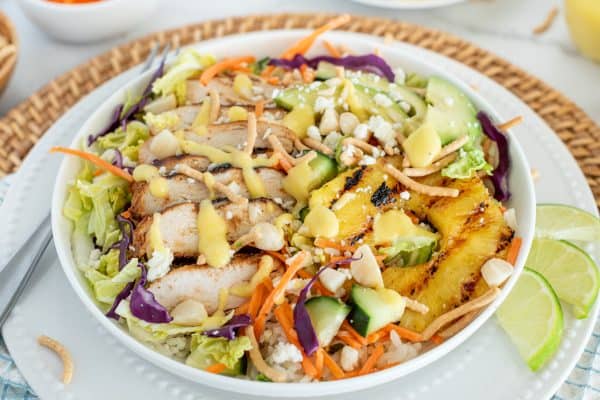 Chicken Salad with cabbage, carrots, pineapple, and mango dressing in a white bowl