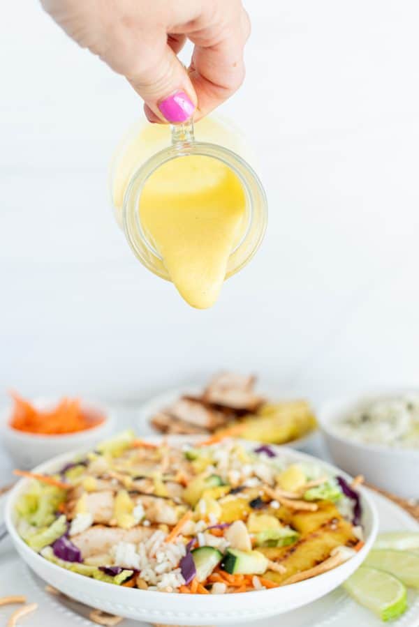 Chicken Salad with cabbage, carrots, pineapple, and mango dressing in a white bowl